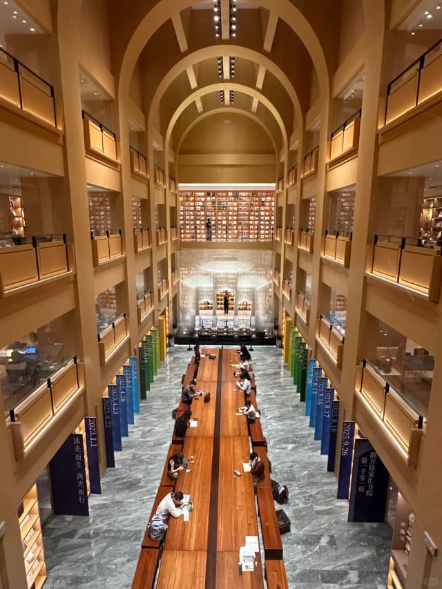 The Xujiahui Library features a stunning Basilica-style atrium and an impressive 20-meter-long 'Haishang Desk'.